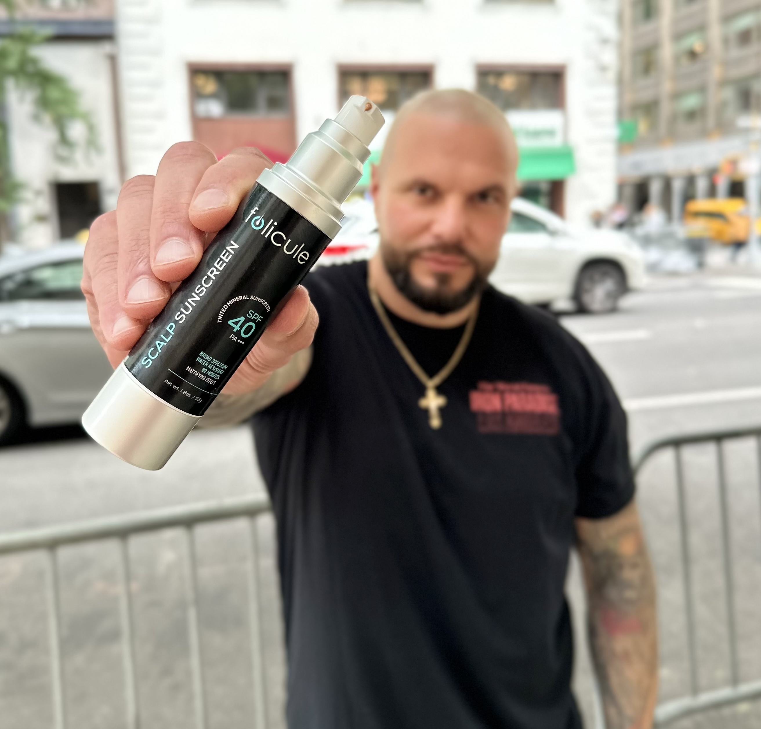 Folicule customer holding Scalp Sunscreen SPF 40
